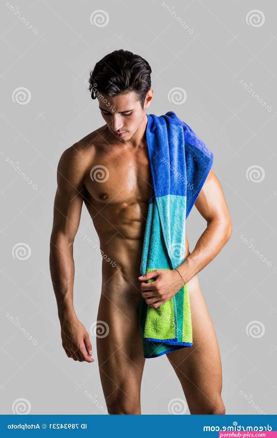 Naked Muscular Man Covering Crotch with Shirt Stock Image
