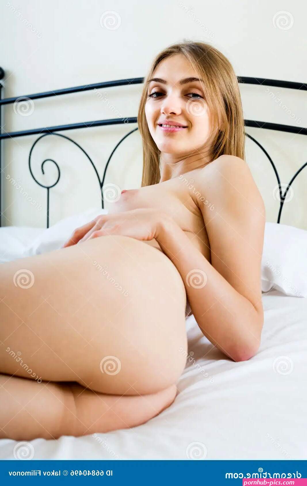 Seductive Woman with Naked Body Lounging in Bedroom Stock Photo