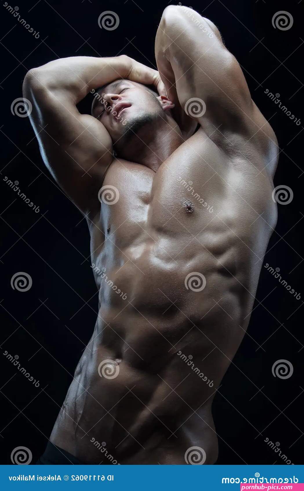 Bodybuilder and Strip Theme: Beautiful with Pumped Muscles Naked Man Posing in the Studio on a Dark Background Stock Photo