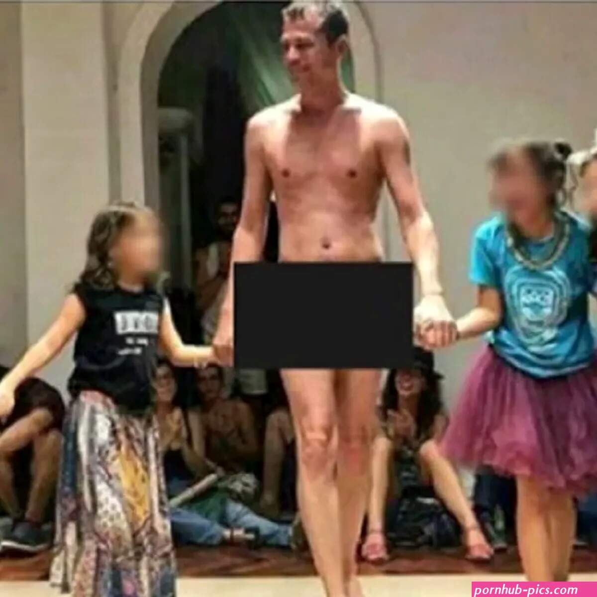 Does This Photograph Show a Nude Man Walking the Runway with a Group of Young Girls?