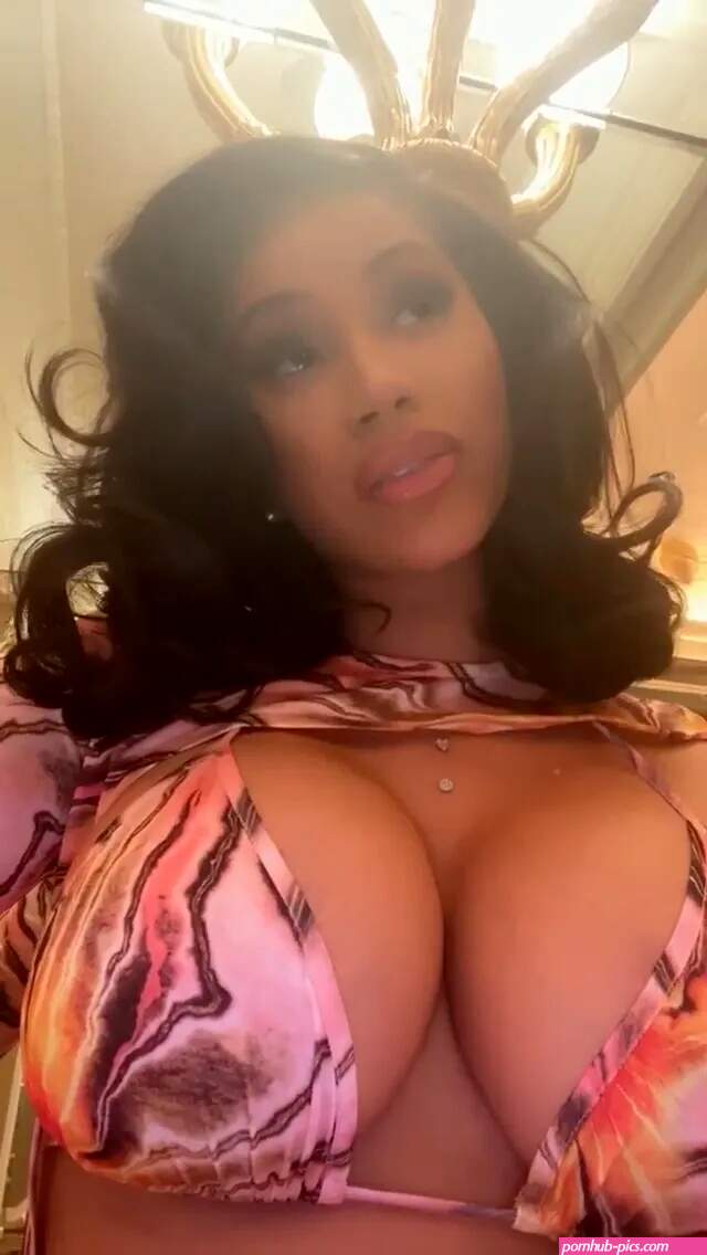 Cardi B flaunts her ample cleavage in a nude bra as she packs on the PDA with on-again husband Offset