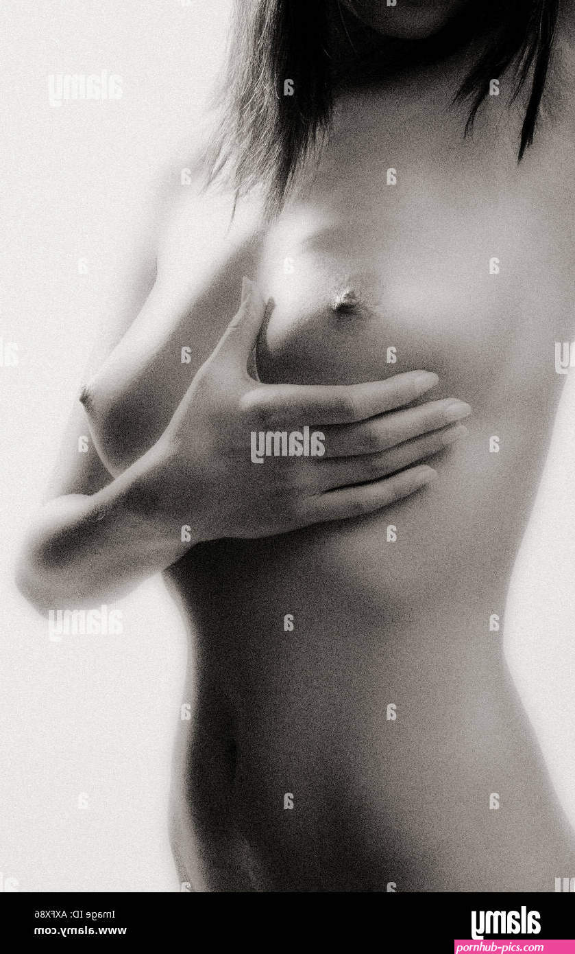 indoor studio fragment woman young girl naked stand study breast prevention close up black white vertical Stock Photo