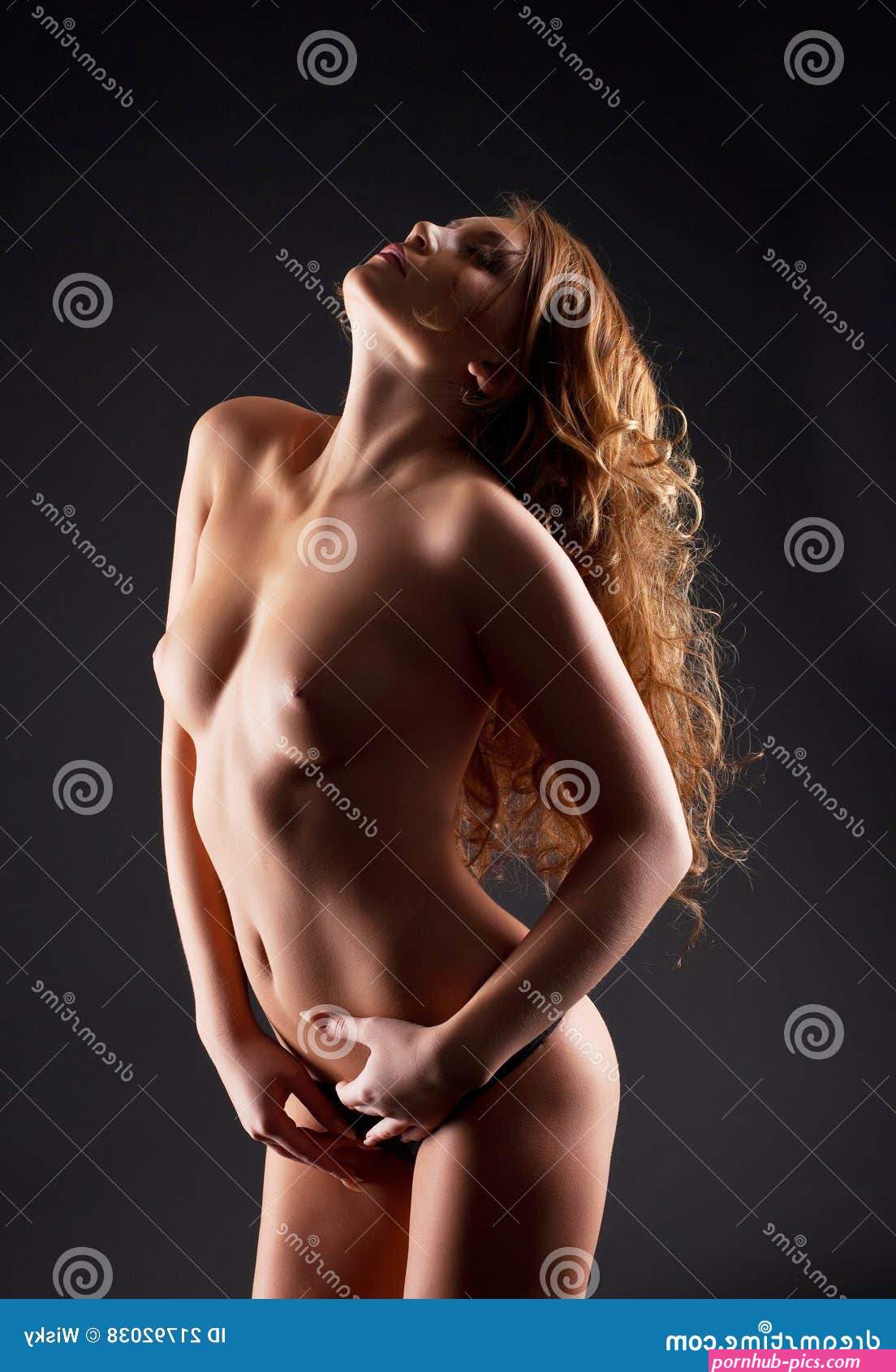 Girl with Naked Breast Posing in Dark Stock Photo