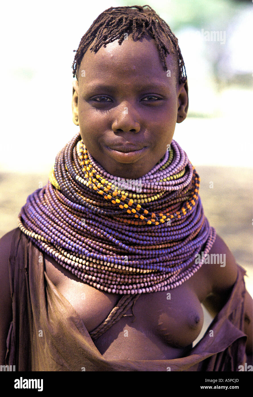 Young Turkana woman wearing typical blue bead necklaces Lokichar northern Kenya East Africa Stock Photo