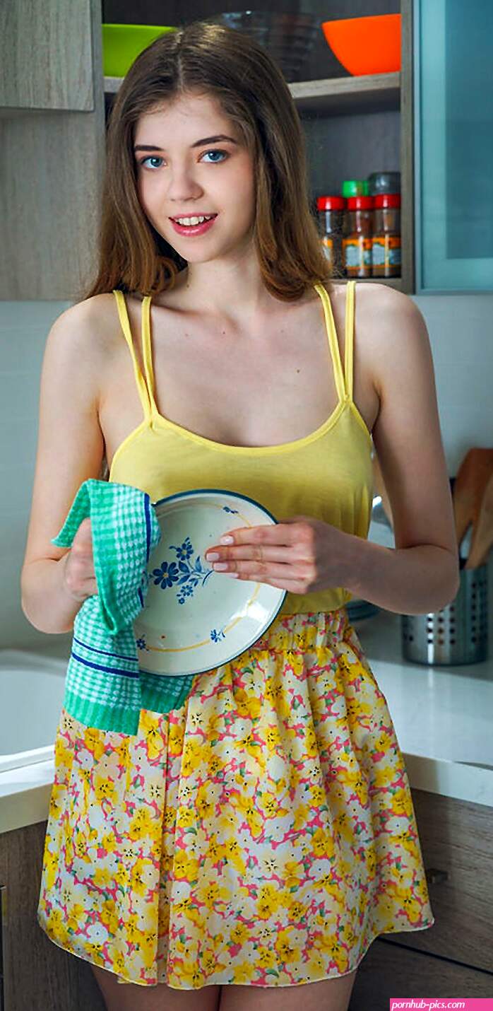 Young cute girl Kay J undresses for nude posing on kitchen counter