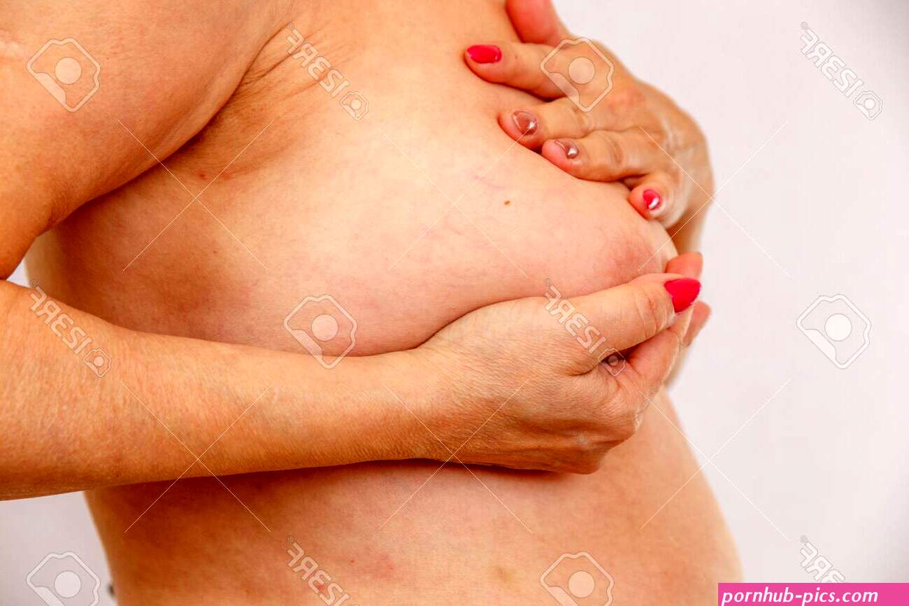 60 Year Old Older Woman Checks Her Big Breasts For Cancer On A Light Isolated Stock Photo Picture and Royalty Free Image. Image 128295978.