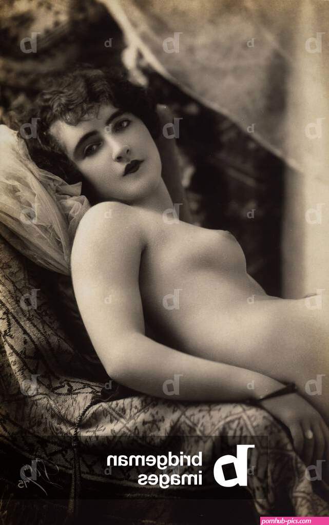 Image of A young woman posing nude on a couch by Unknown photographer 20th century