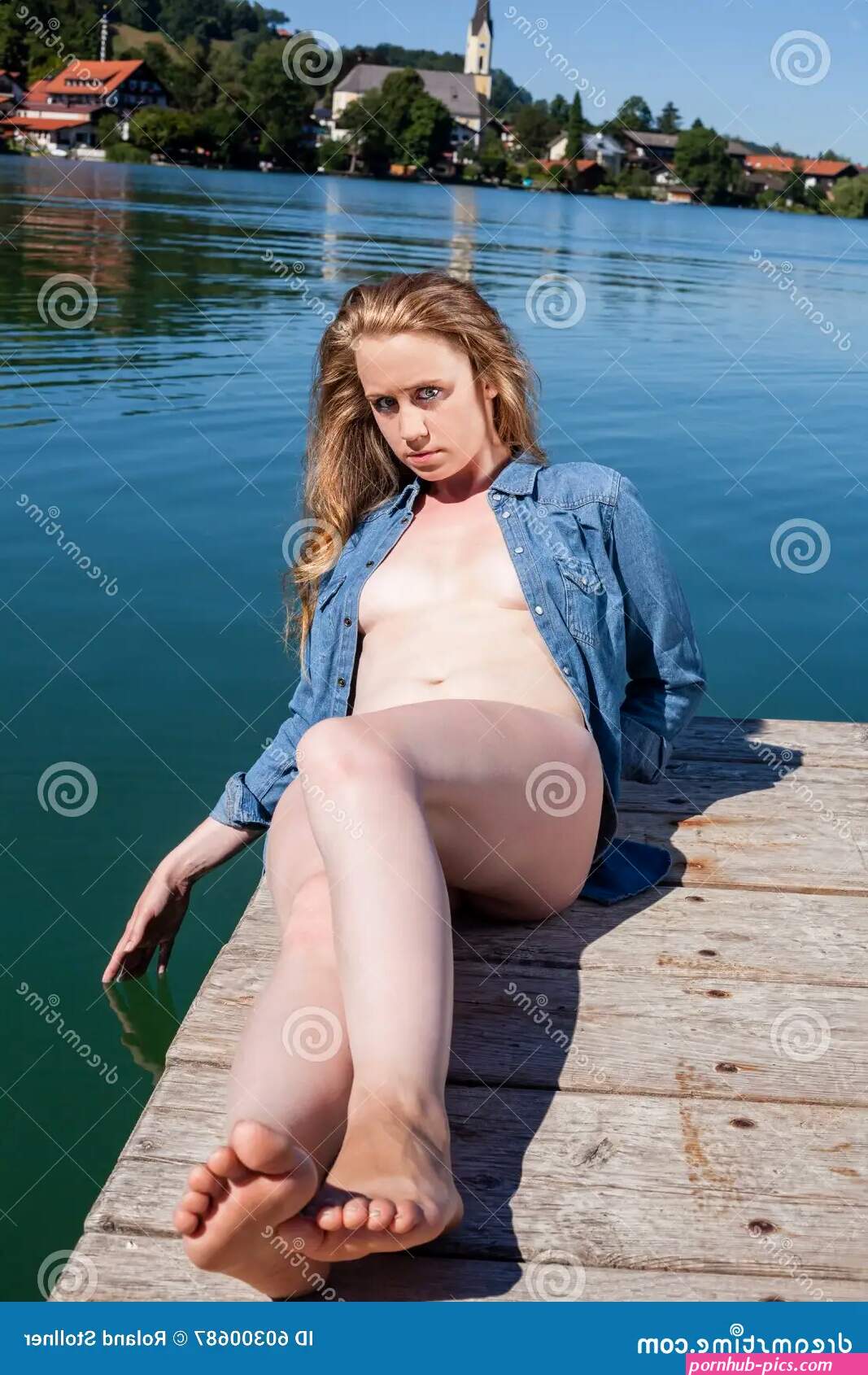 Young Woman Sunbathing Nude on Lake Dock Stock Image