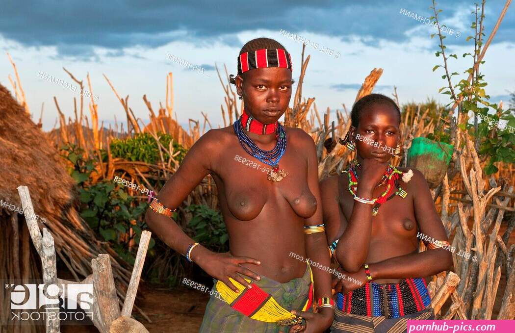 Turmi Ethiopia Africa village Lower Omo Valley Hamar Hammer tribe two nude teemager girls at sunset... Stock Photo Picture And Rights Managed Image. Pic. ZF6-1852938
