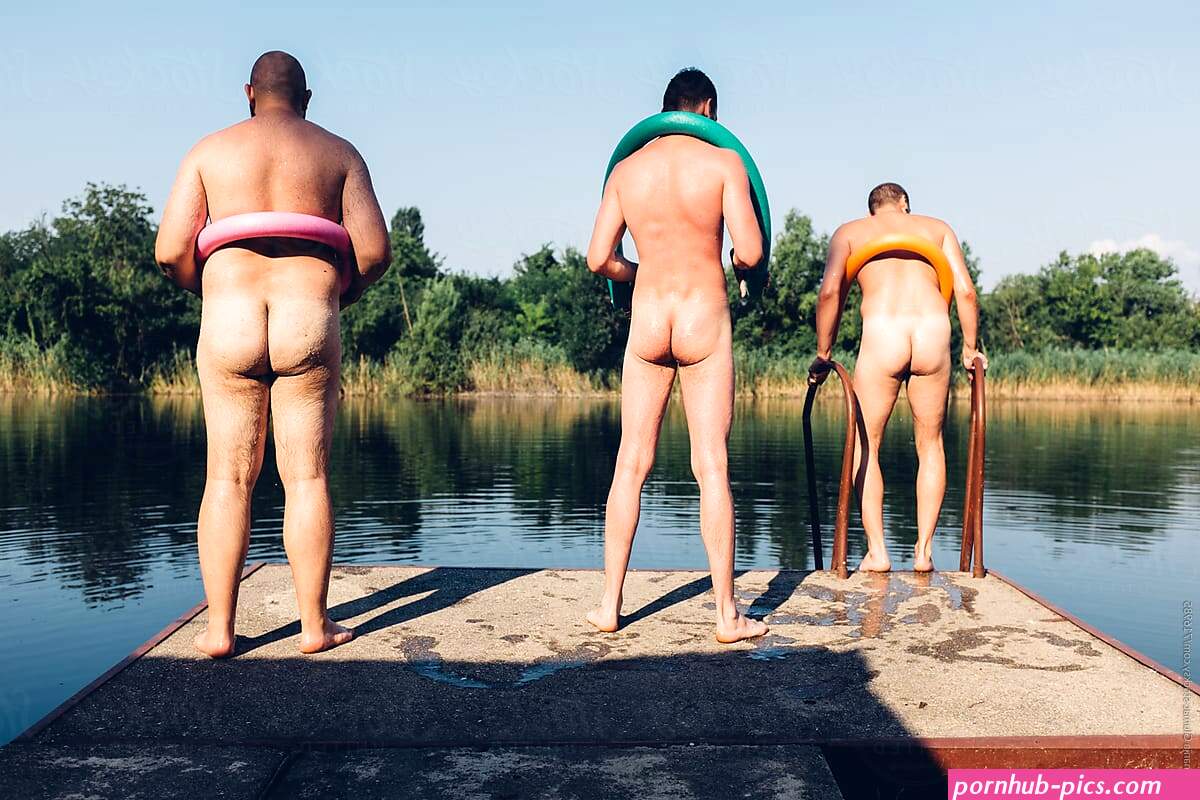 Three Funny Naked Man On A Dock With Swimming Noodles by Stocksy Contributor Nemanja Glumac