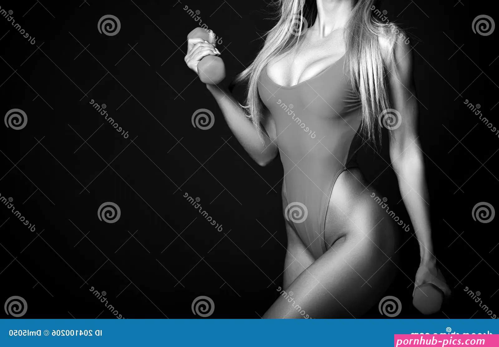 Fitness Woman in Bikini with Perfect Boobs and Buttocks Standing with Dumbbels in Hands during Sport Workout Stock Photo