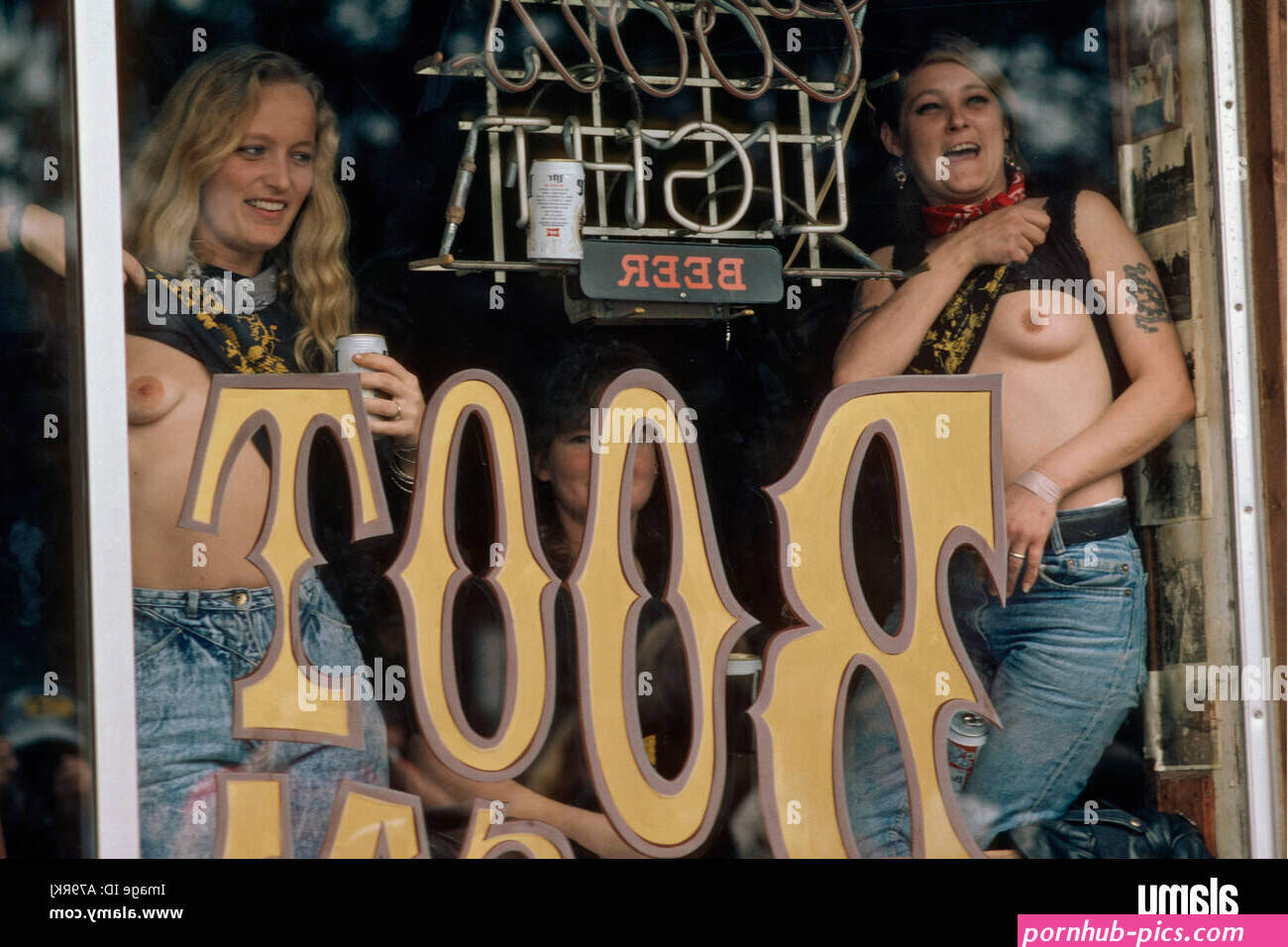 Women in a bar flashing breasts during Bike Week in Daytona Beach Florida USA Stock Photo