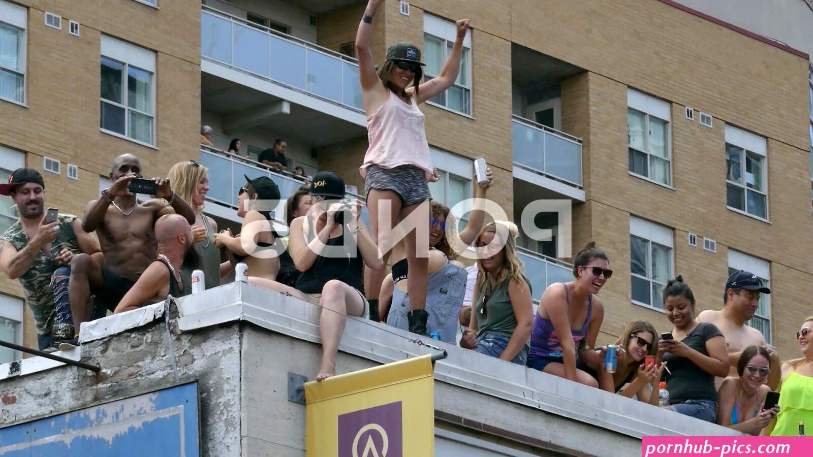 Woman flashing breasts during gay pride...