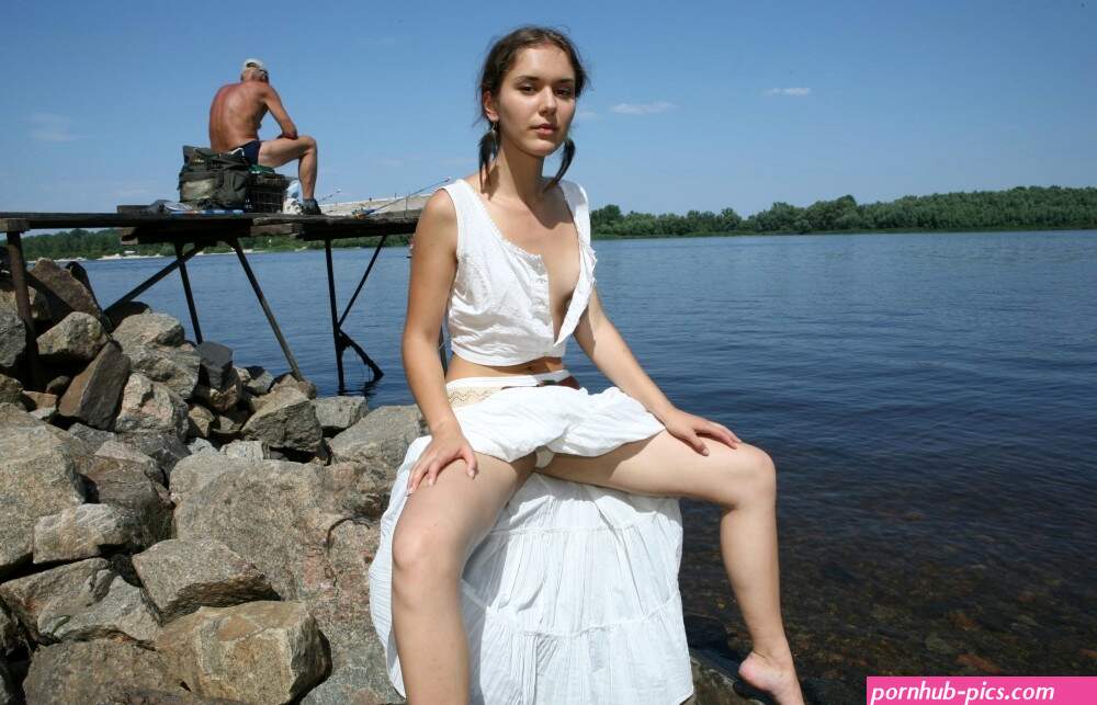 Young naked girl is photographed next to the fisherman Russian Sexy Girls