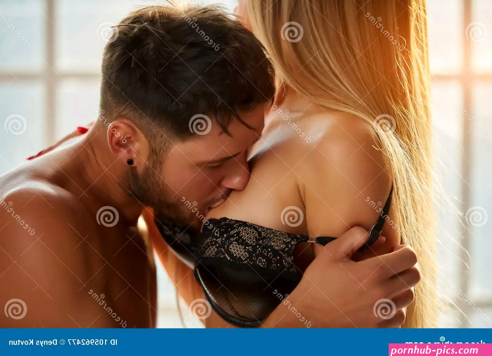 Man Kissing Womans Breast. Stock Image