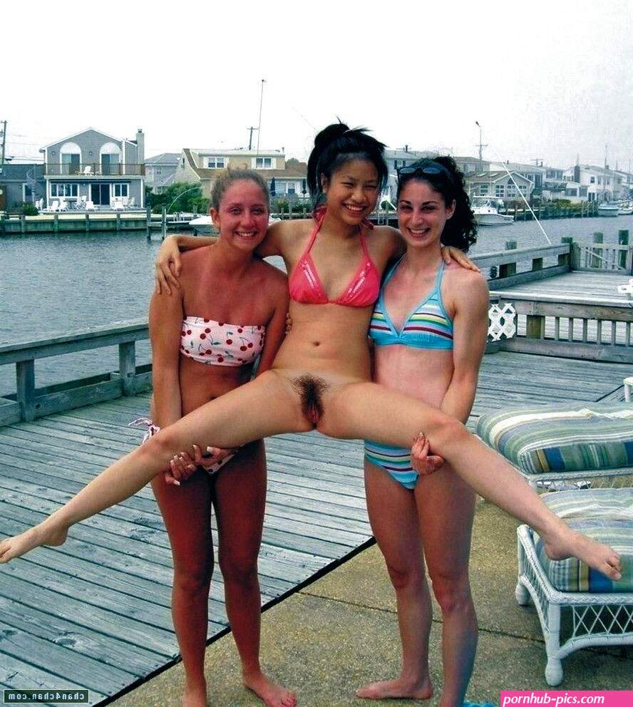 Two friends holding up a naked one. Porn Pic
