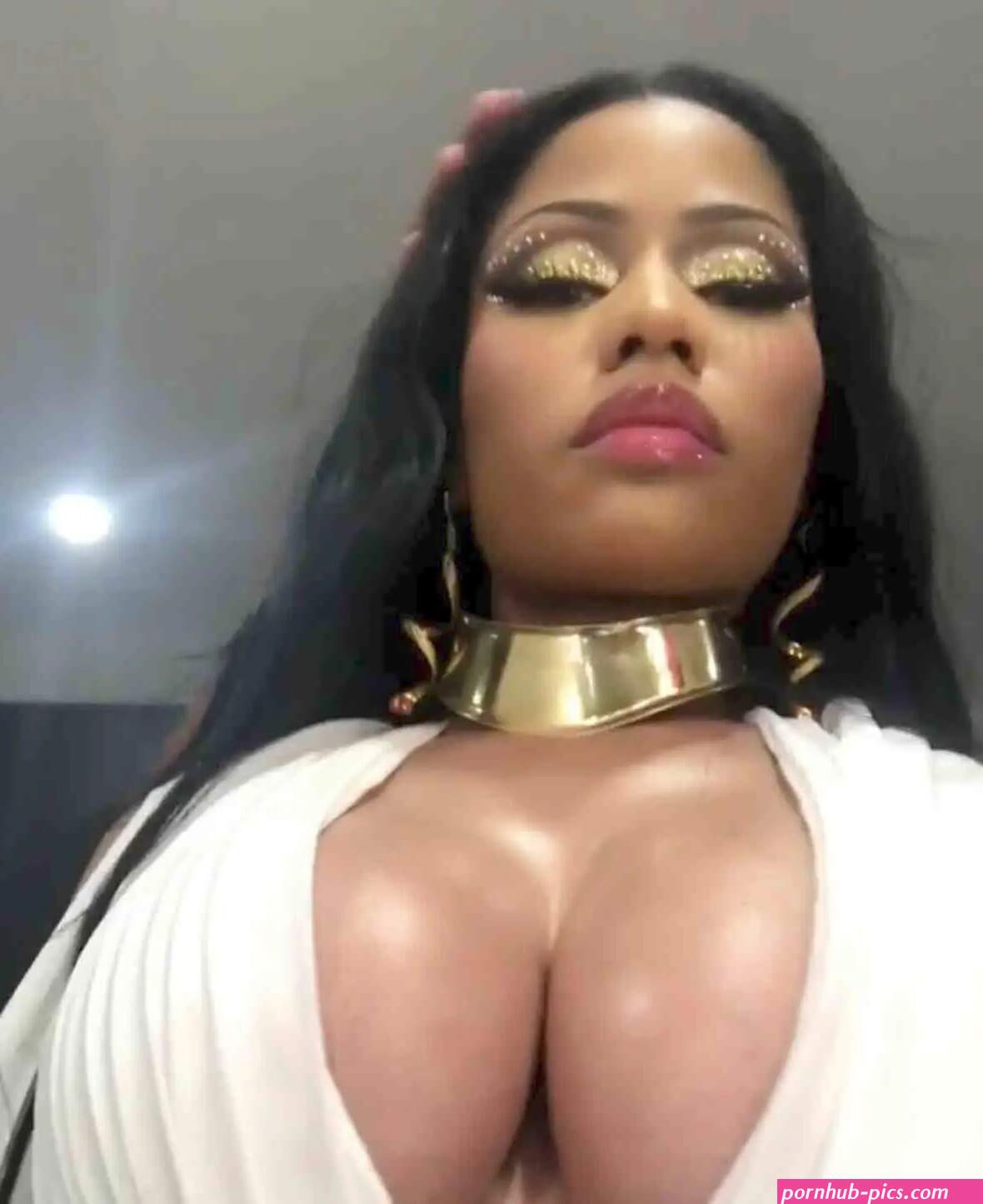 Nicki Minaj shows off eye-popping cleavage in a plunging Greek goddess-style costume for a sizzling secret shoot video