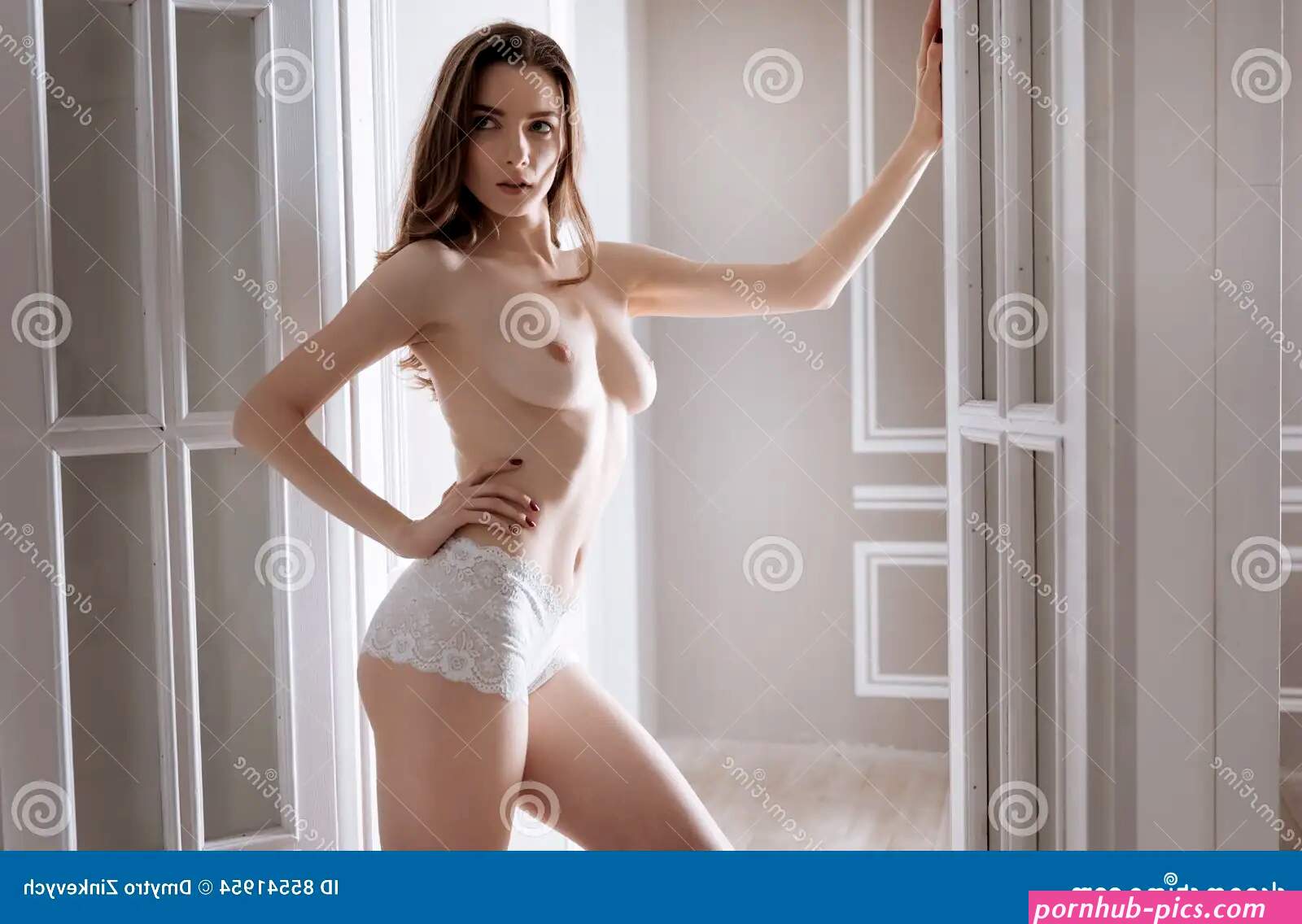 Beautiful Young Woman with Nude Breast Looking Aside Stock Photo