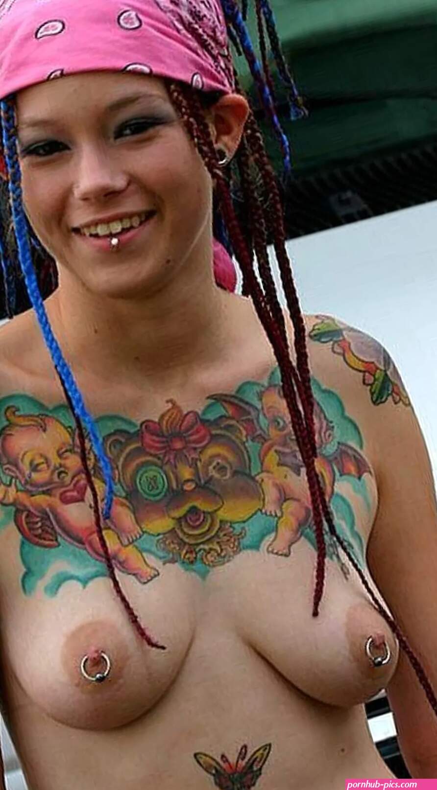 Woman tattoos piercings topless