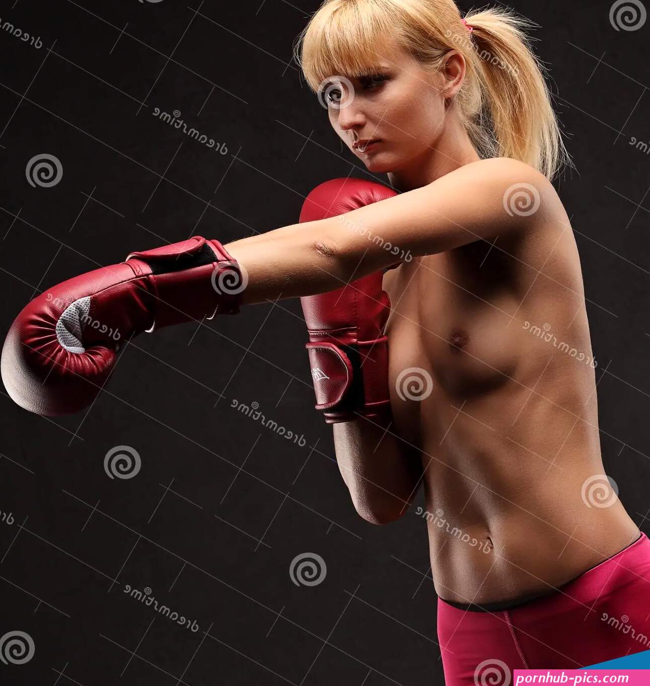 Brunette Posing Topless in Boxing Gloves Stock Image