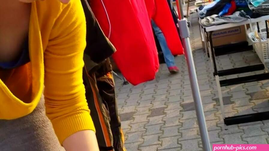 Street market seller has her big cleavage caught on the camera