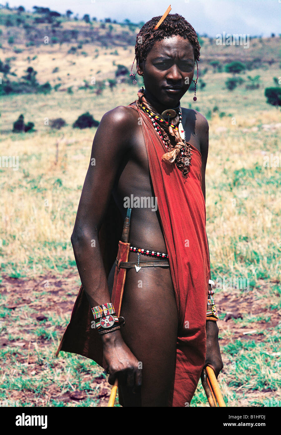 Maassai moran or warrior with traditional beads sword and shuka Masai Mara National Reserve Kenya East Africa Stock Photo