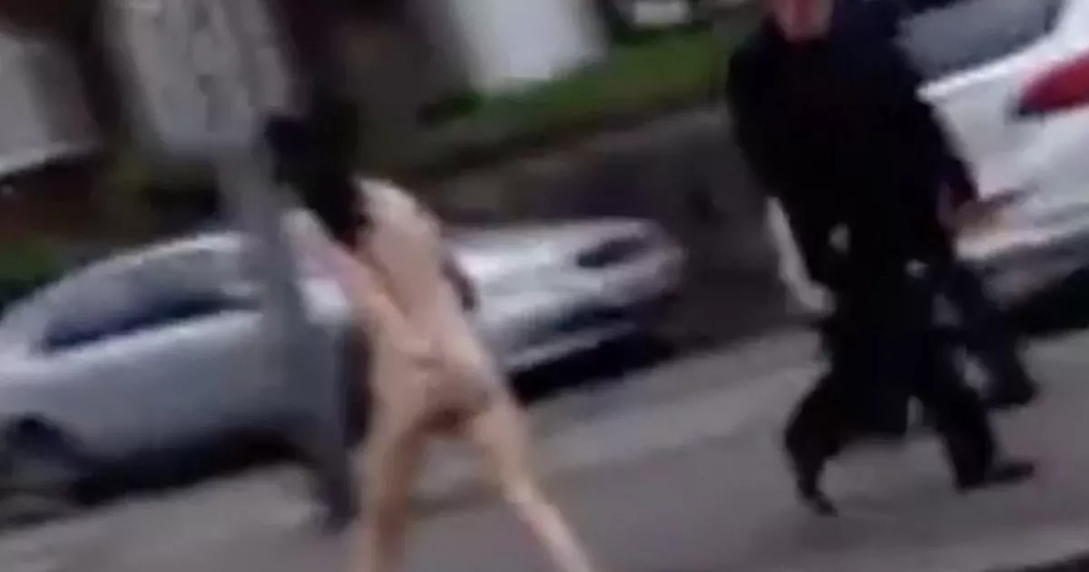 Mystery naked woman looking distressed spotted running through the street by onlookers