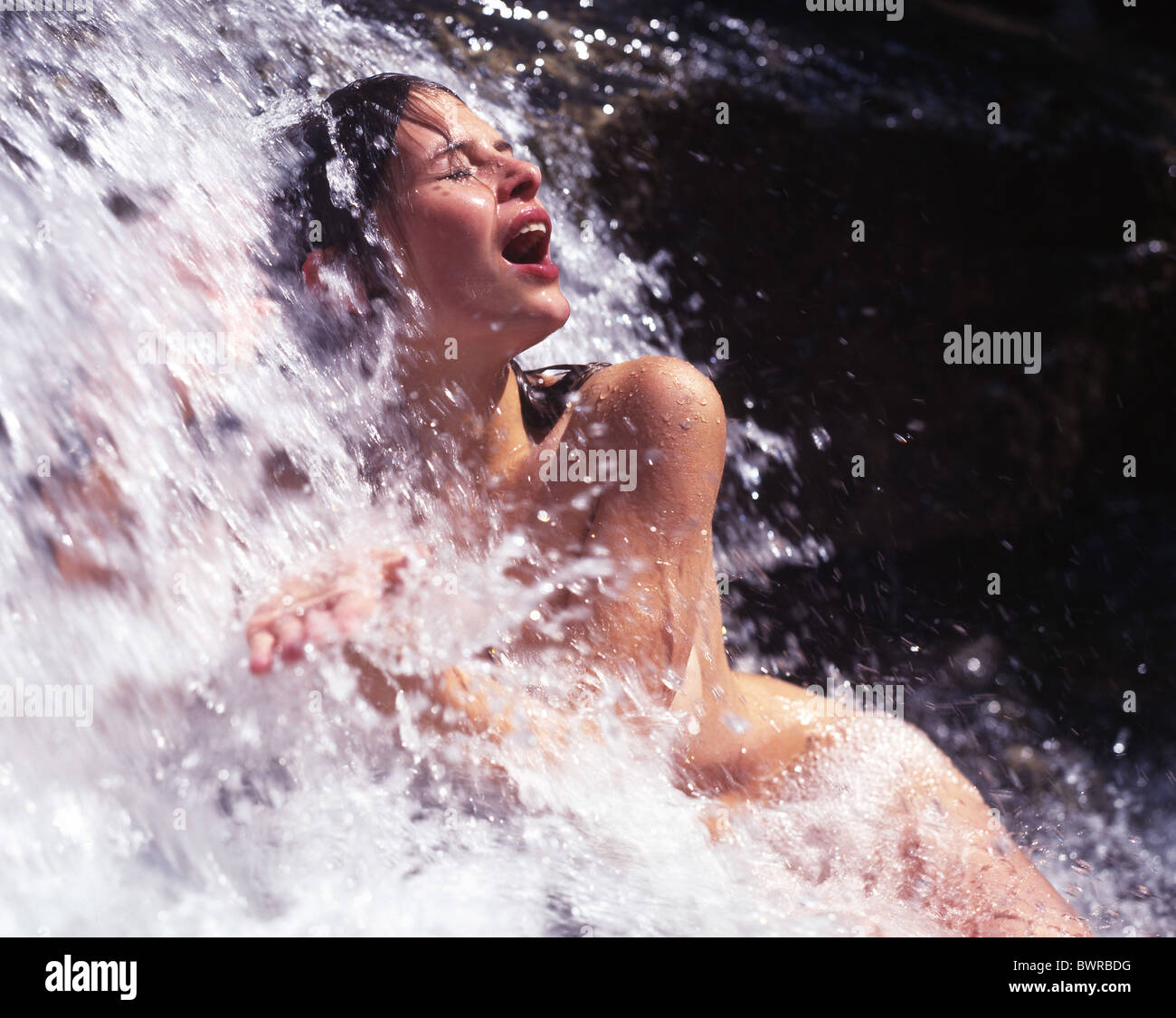 Woman naked nude outdoor outdoors bathing waterfall water brook stream creek bath wellness recreation na Stock Photo