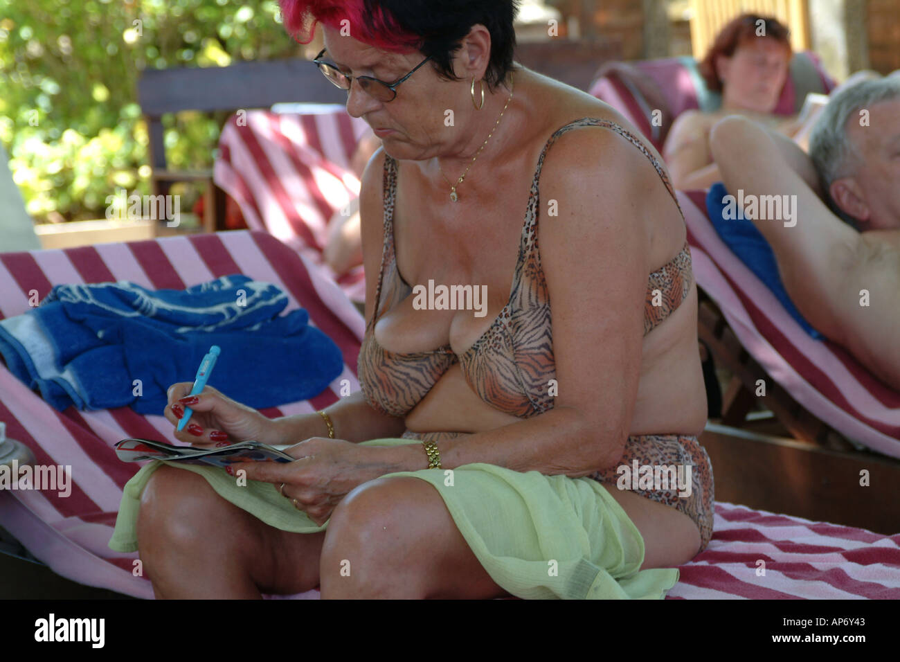 German tourist doing puzzles in swimsuit Bali Stock Photo