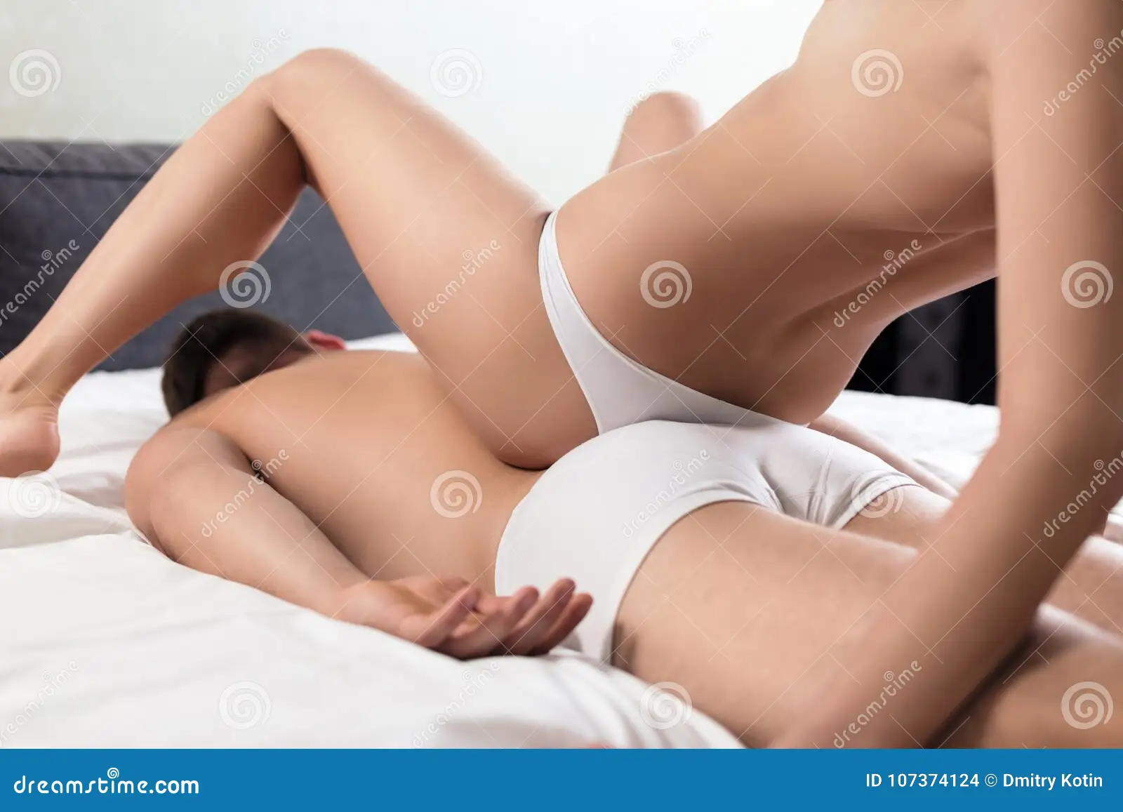 Couple Doing Erotic Massage in Bedroom. Stock Photo