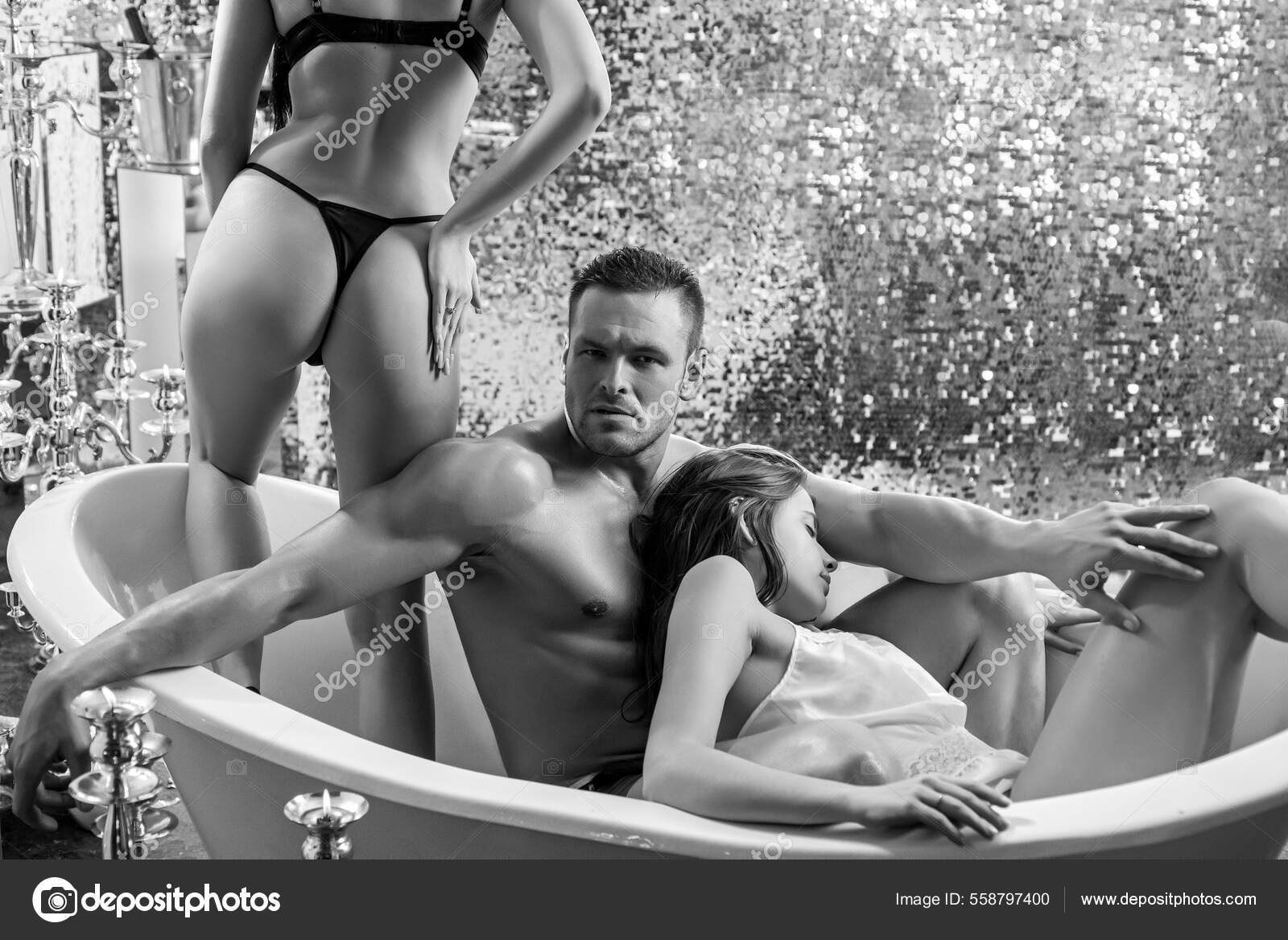 Sexy people in bathroom. Threesome concept. Three people having group sex together. One man and two