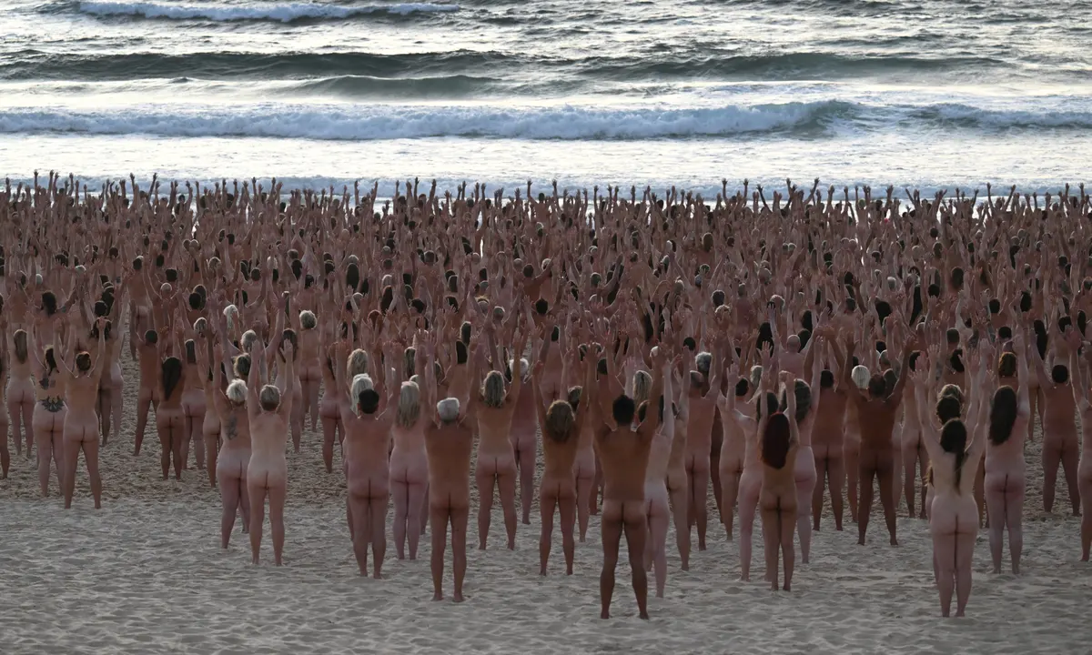 Bondi becomes nude beach as thousands take part in Spencer Tunicks Sydney installation
