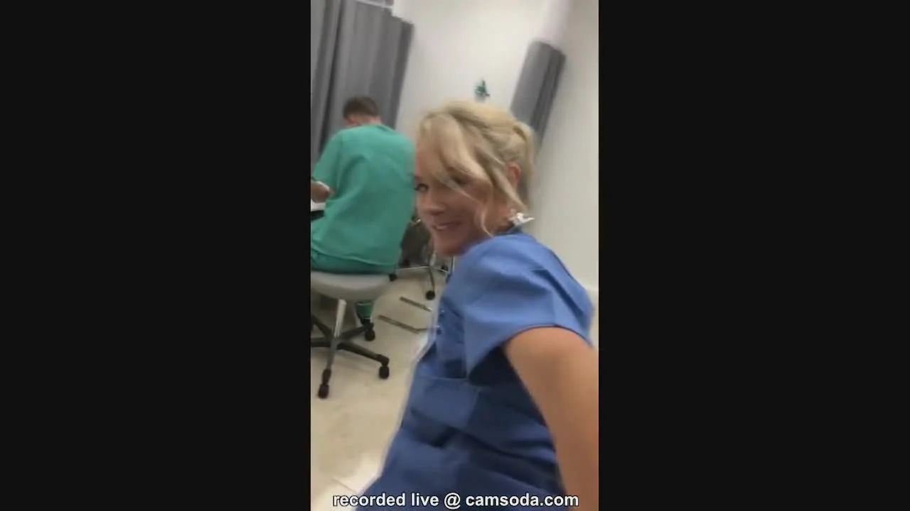 A naughty nurse masturbates in front of a mirror