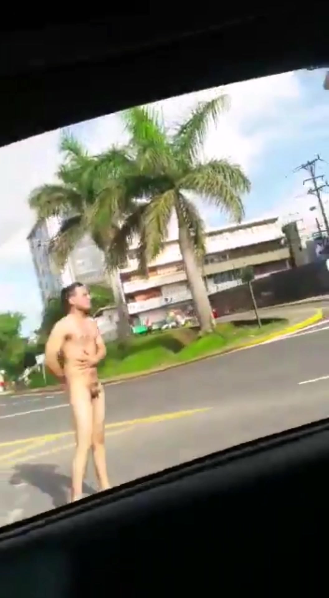 Nude man in public street
