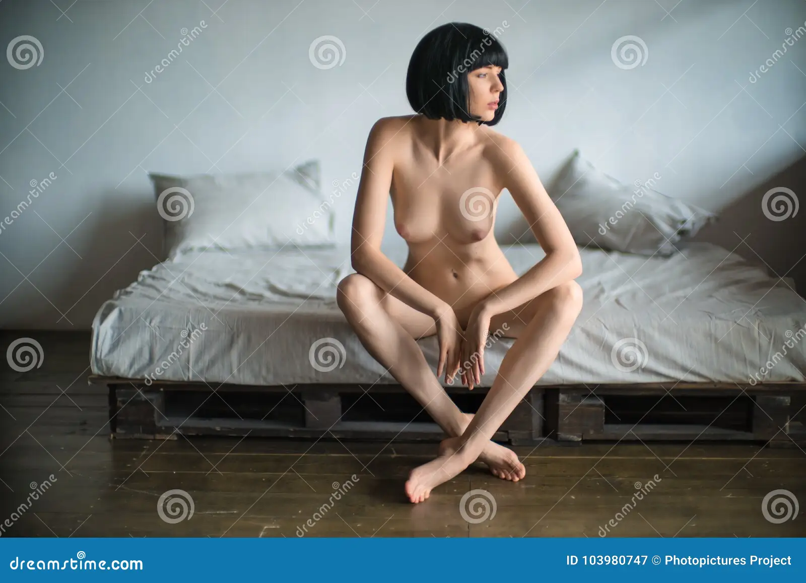Brunette Woman Sitting Nude in Bed Stock Image