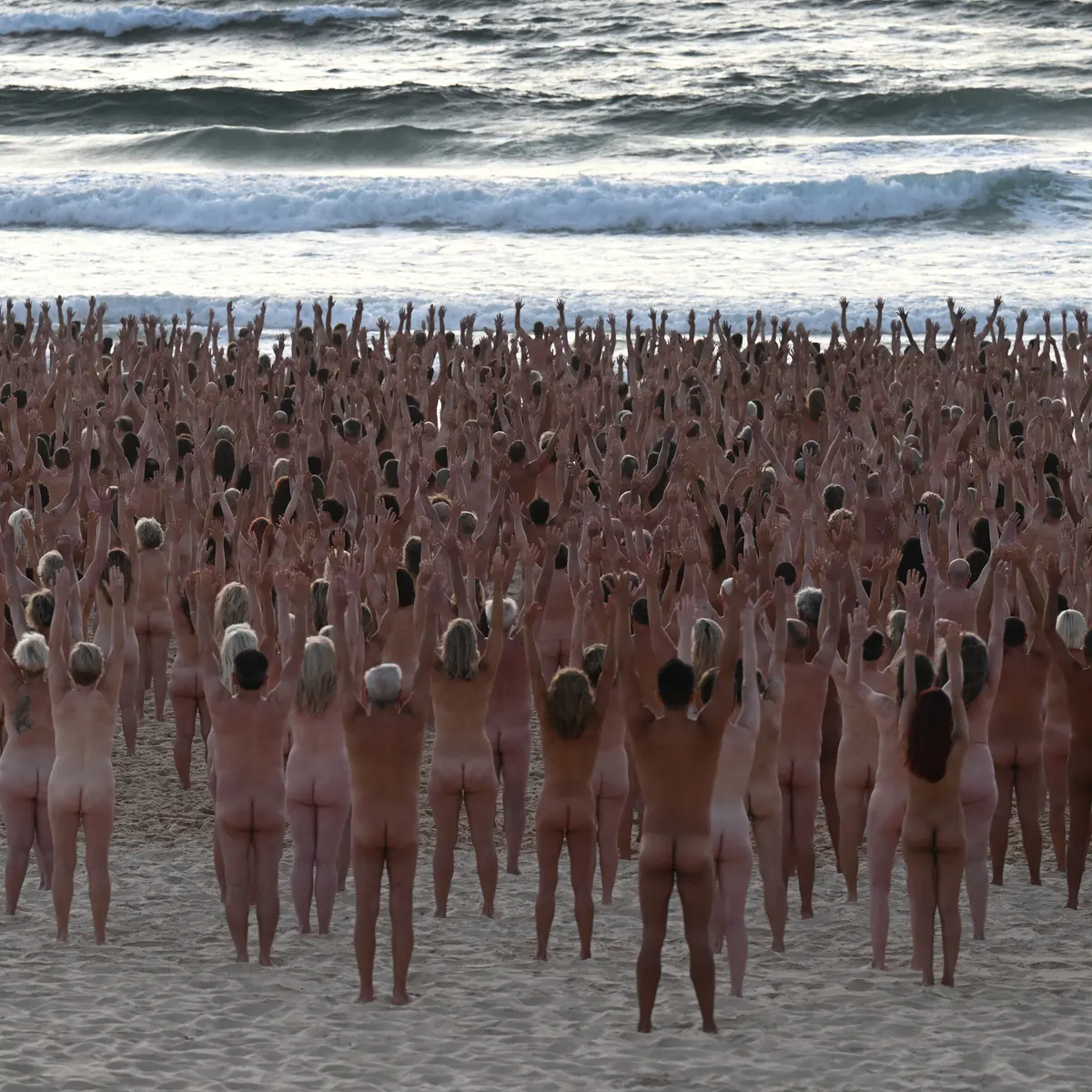 Bondi becomes nude beach as thousands take part in Spencer Tunicks Sydney installation