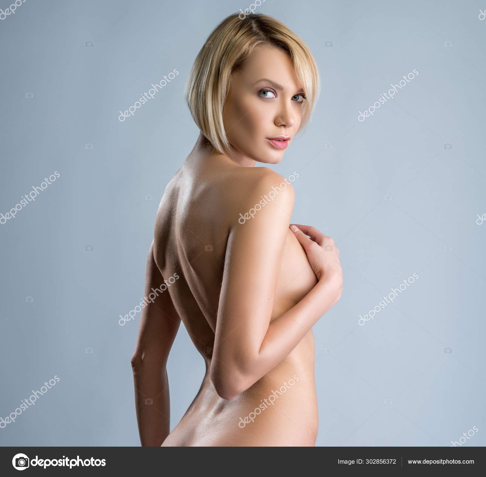 Naked woman looking over her shoulder coquettishly Stock Photo Wisky 302856372