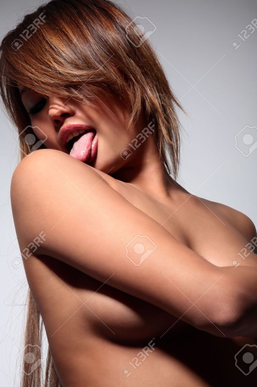 Young Sexy Nude Woman Is Licking Her Shoulder On Gray Stock Photo Picture and Royalty Free Image. Image 4812892.