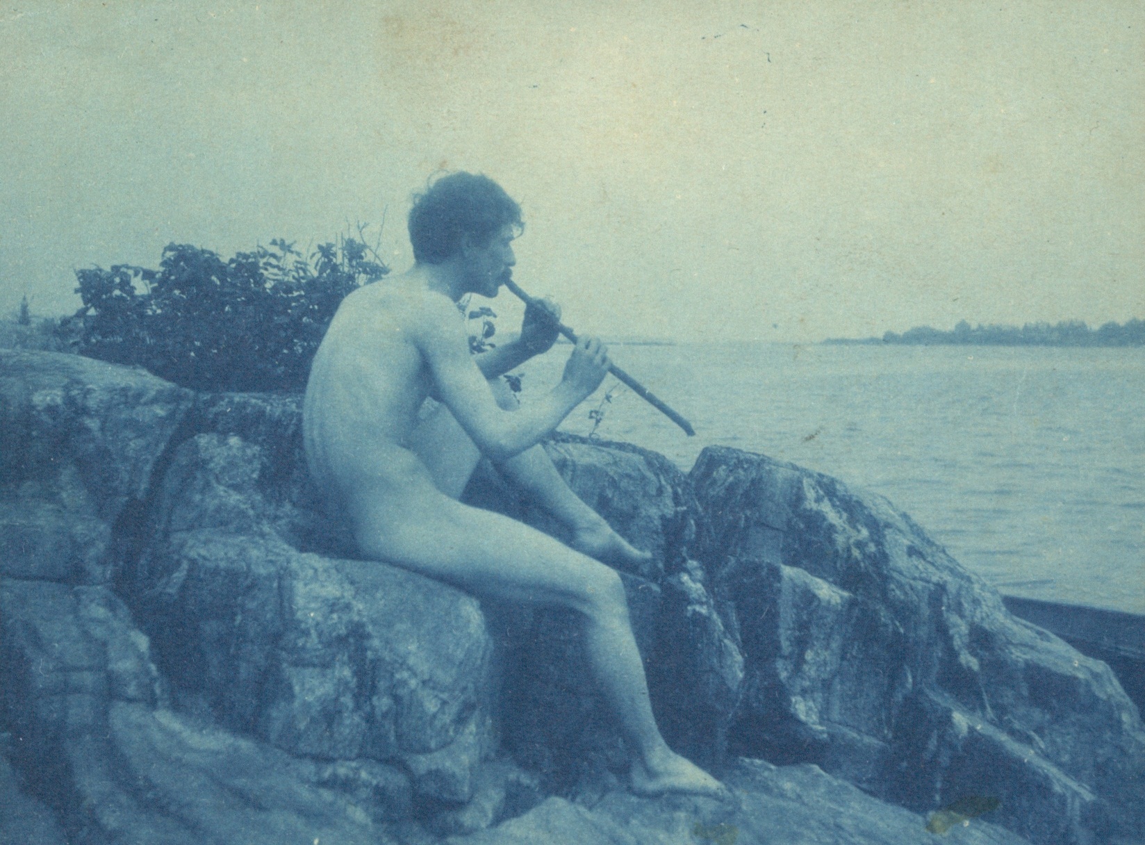 File:Man posed on rocks nude playing pipe Pan photograph by Frances Benjamin Johnston
