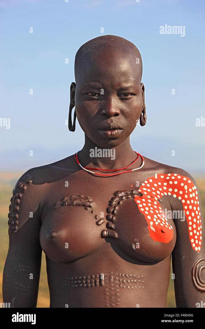 in Maco National Park woman from the tribe of Mursi Mursi woman my naked torso and painted skin Stock Photo