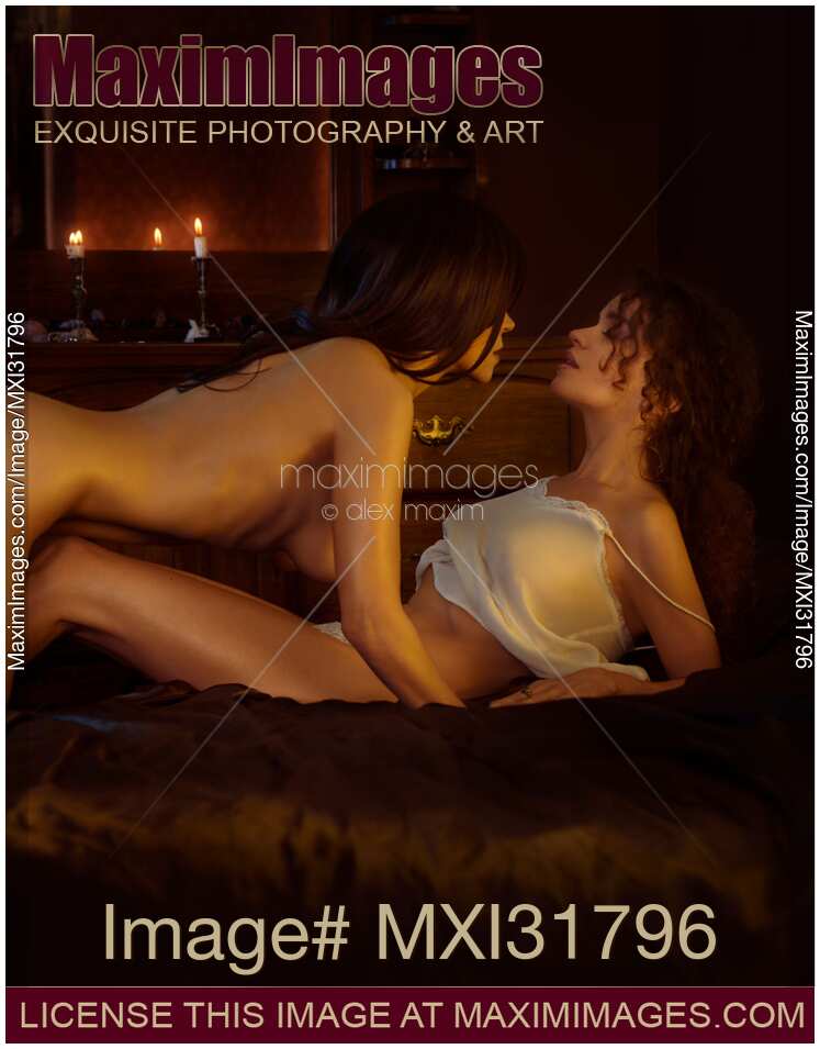 Photo of Two beautiful sexy ladies making love in bed romantic lesbian couple kissing