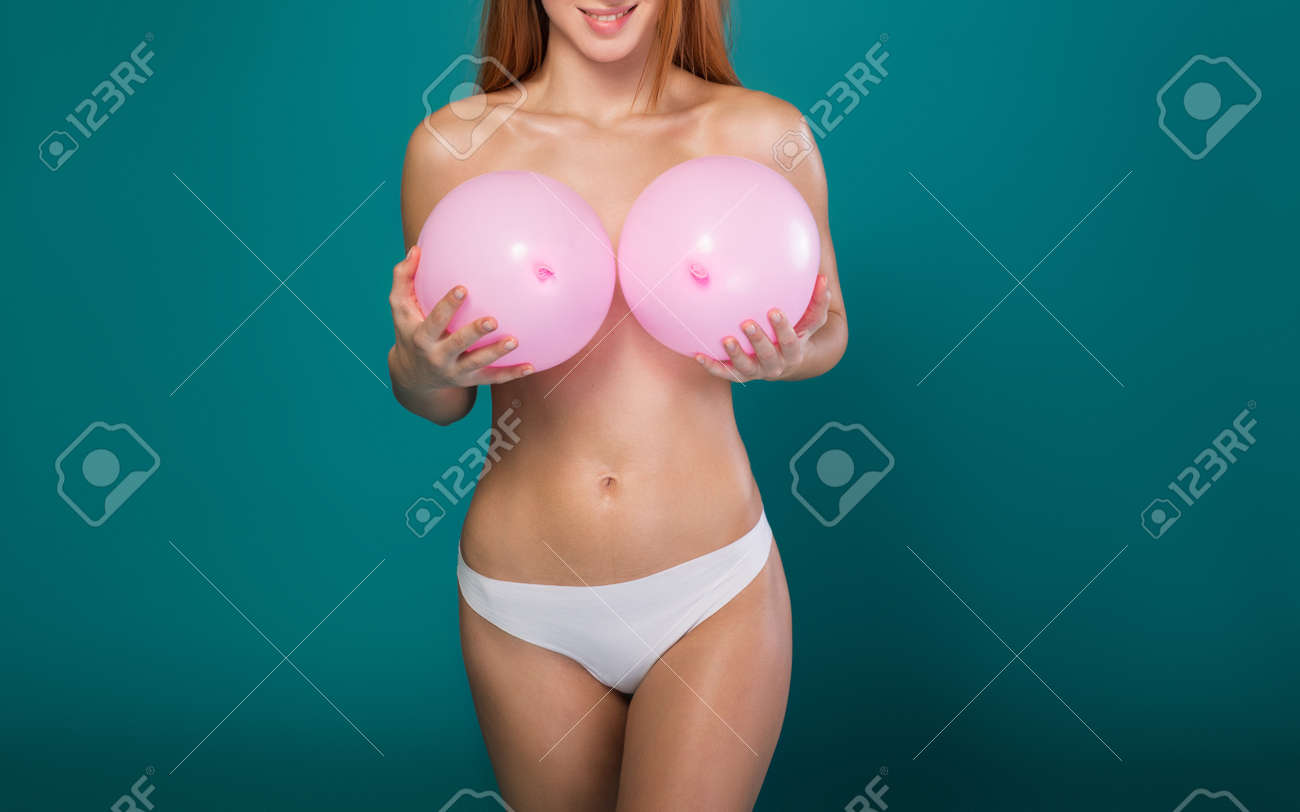 I Want Big Boobs. Joyful Young Naked Woman Is Holding Two Pink Balloons Near Her Breast. She Is Standing And Smiling. Isolated Stock Photo Picture and Royalty Free Image. Image 99771114.