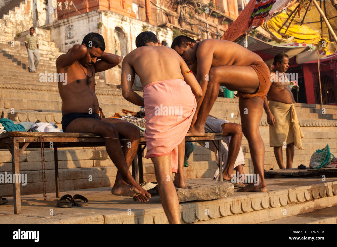 Indian men on the ghat after bathing Varanasi India Stock Photo