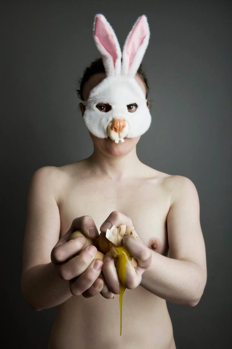 Nude with bunny mask breaking raw eggs Photography by Jan Tepass