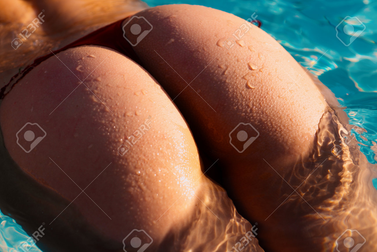 Sensual Ass In Swimming Pool Close Up Summer Journey Woman With Hot Natural Butt Relax In Water. Wet Body Backside In Sexy Bikini. Seduction And Pleasure Model. Luxury Passion Buttocks. Stock Photo
