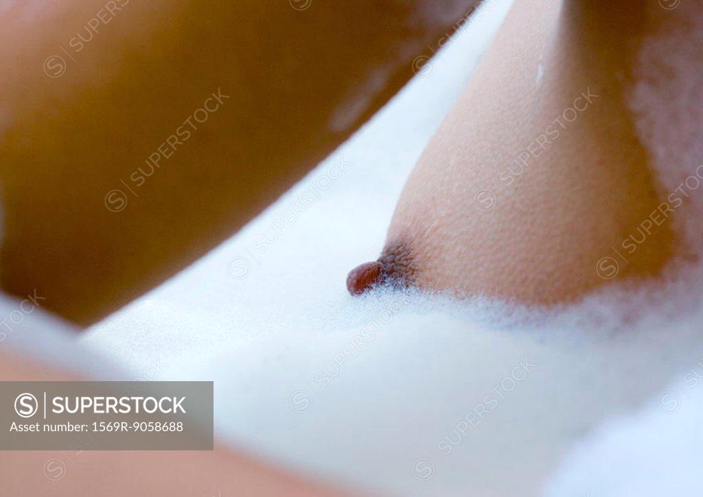 Womans breast in bubble bath