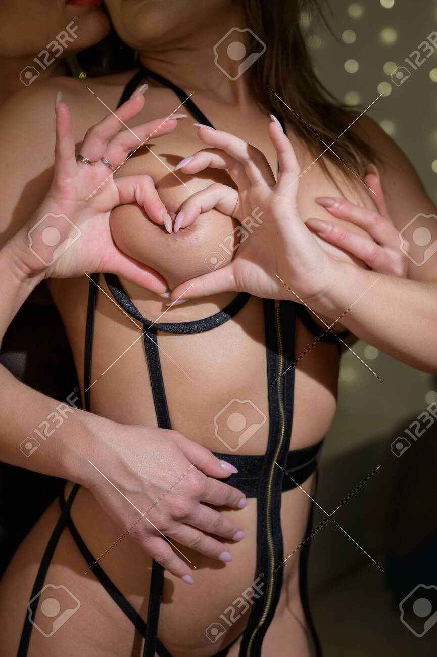 Happy Valentines Day. Two Lesbians Show Love. A Woman Hugs A Partner From The Back And Caresses Her Boobs. Heart Sign With Hands. Stock Photo Picture and Royalty Free Image. Image 158487341.