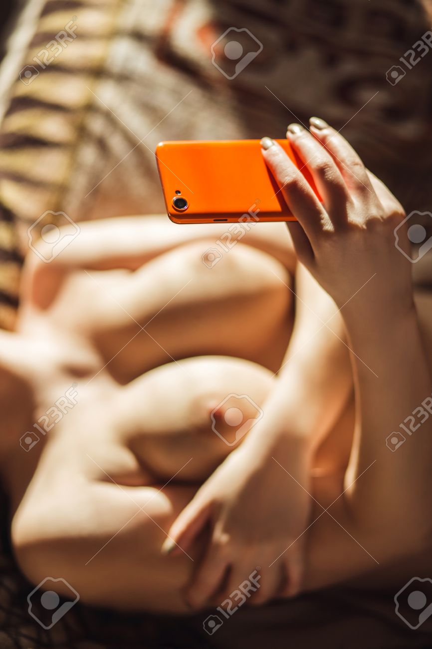 Busty Girl Makes A Selfie Of Their Breasts While Lying On The Sofa In Sunlight. Stock Photo Picture and Royalty Free Image. Image 55067258.