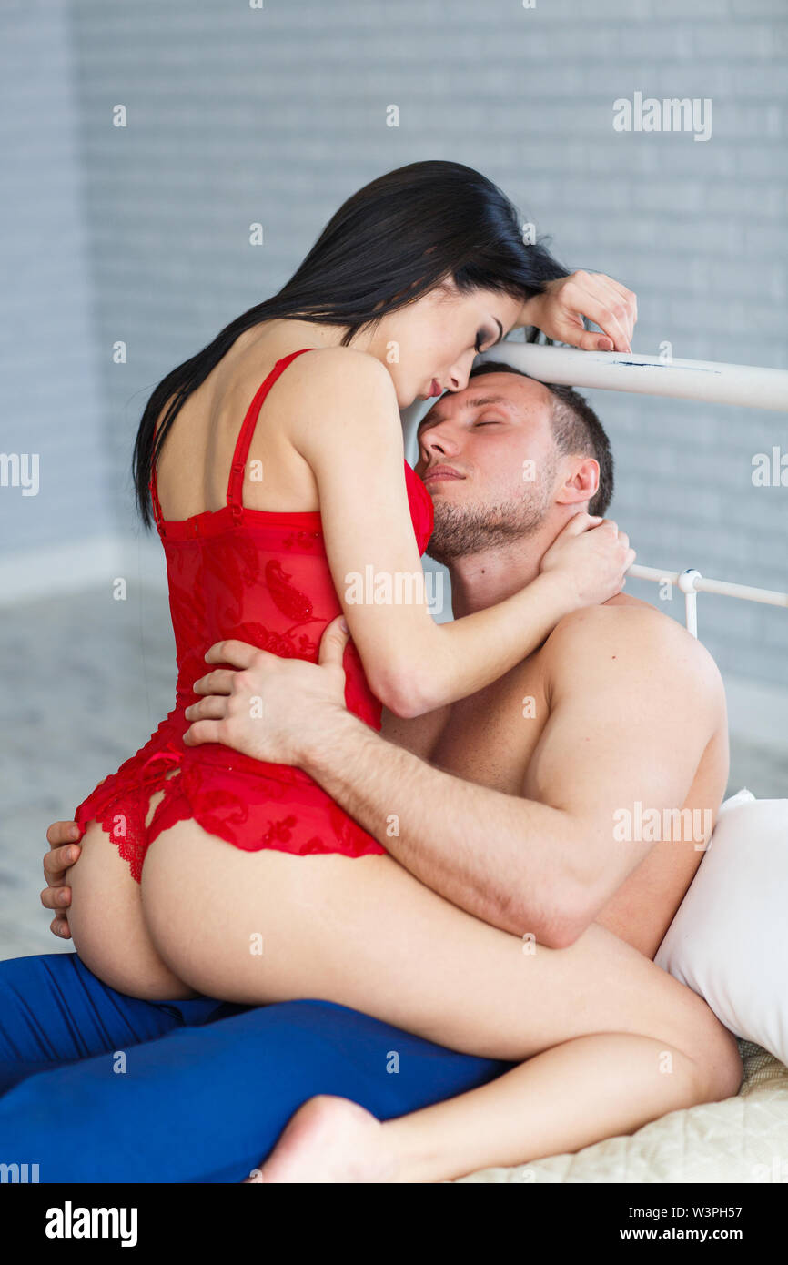 Sexy young couple kissing and playing in bed Stock Photo