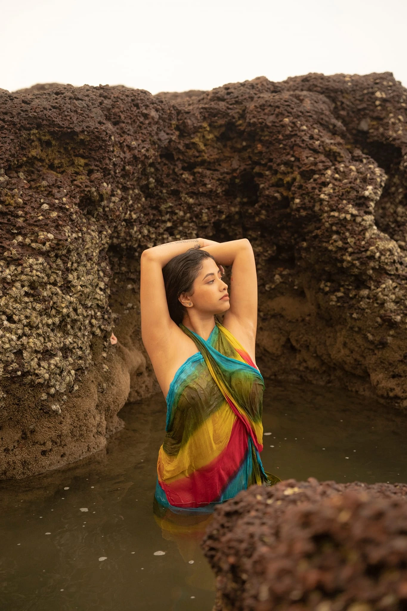 Desi model in a braless wet saree and showing glimpses her big boobs and nipples clearly while posing in a reef beach